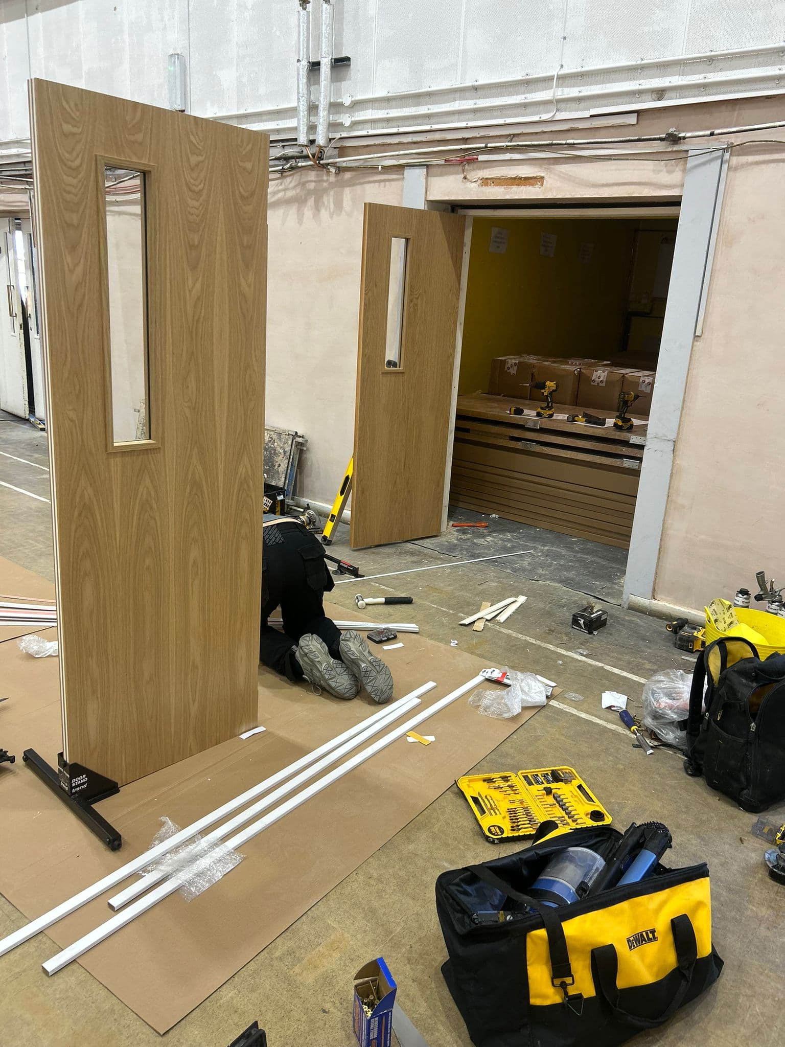 Oak veneer fire doors being fitted on site