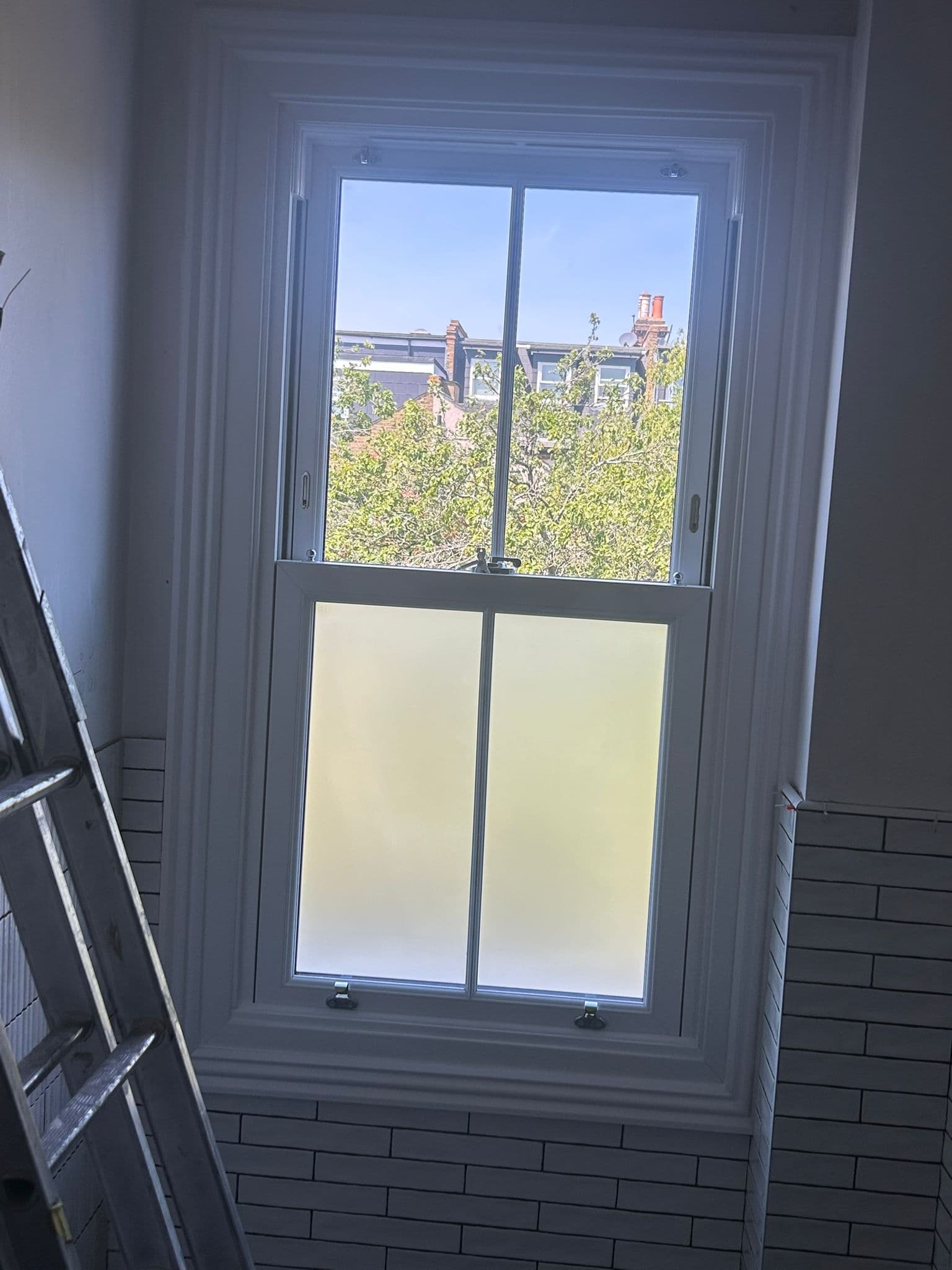 Bathroom sash window with frosted lower pane for privacy — London