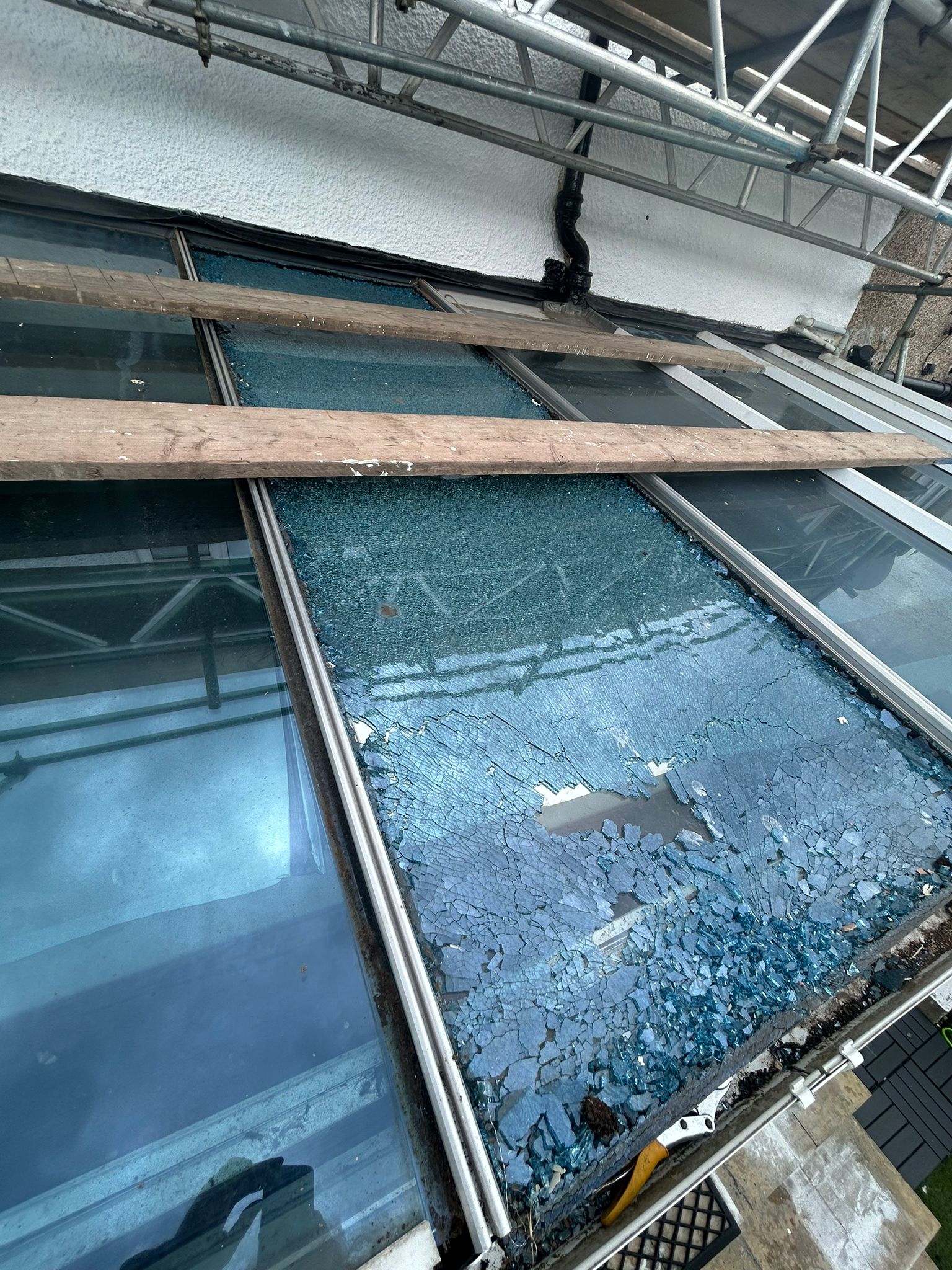 Before — shattered toughened glass on conservatory roof, London