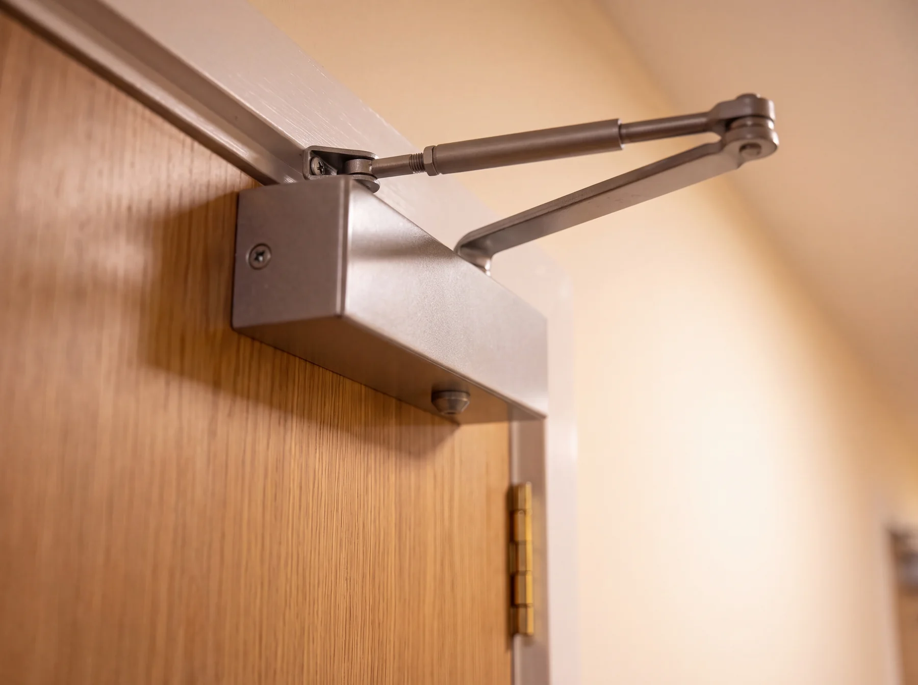 Certified overhead door closer mechanism on a fire door